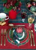 A festive Christmas table setting with plaid-themed decorations, including plates, napkins, ornaments, and a floral arrangement. Produktbild-Vorschau