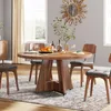 A dining room scene with a round wooden table set for a meal, surrounded by chairs, with a decorative mirror on the wall. Podgląd zdjęcia produktu