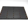 A black rubber doormat with brown coir bristles visible in cutouts. Produktbild-Vorschau