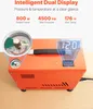 An orange air compressor with dual displays and gauges, placed on a wooden surface. Produktbild-Vorschau