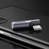 A Ugreen USB-C to 3.5mm audio adapter is shown on a dark, reflective surface, possibly a phone. Podgląd zdjęcia produktu