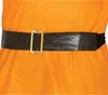 Close-up of a black belt with a gold buckle on an orange garment. Produktbild-Vorschau