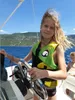 A young person is steering a boat on a sunny day. Náhled obrázku produktu