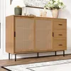 A wooden sideboard with cane doors and black legs, placed on a wooden floor with a rug in front. Anteprima dell’immagine prodotto