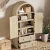 A light wood cabinet with an arched top, open doors, and two drawers, filled with books and decorative items. Podgląd zdjęcia produktu