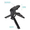 A black mini tripod stand for a smartphone or camera is shown against a white background. Text labels point out features like 'Standardgewinde Standard Sracew', 'einstellbar adjustable', and 'Gummisohle Rubber sole'. Produktbild-Vorschau