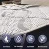 A close-up view of a mattress topper with informational icons at the bottom. Náhľad obrázku produktu