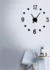 A modern wall clock with black numbers and hands is mounted on a white wall above a white chair and a small side table with a potted plant and a mug. Náhled obrázku produktu