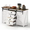 A white sideboard with sliding barn doors and four open drawers, displaying kitchen appliances and fruit on its top surface. Voir les images du produit