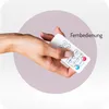 A hand holding a white remote control with various buttons, including play, pause, volume, and music icons. The text "Fernbedienung" is visible. Náhled obrázku produktu