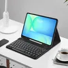 A tablet with a keyboard case is set up on a desk next to a lamp and a cup of coffee. Anteprima dell’immagine prodotto