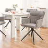 A dining table with chairs in a well-lit room. Voir les images du produit