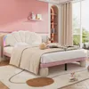 A child's bedroom with a pink wall, a bed with a shell-shaped headboard, and shelves with decorations. Produktbild-Vorschau