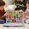 Two children are sitting on the floor in front of a Christmas tree, opening an advent calendar. Podgląd zdjęcia produktu