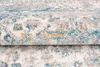 A close-up, folded view of a rug with a distressed pattern. Náhľad obrázku produktu