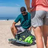 Two people on a beach with a paddle game set. Produktbild-Vorschau