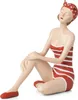 A figurine of a woman in a striped swimsuit and headscarf, sitting with her eyes closed. Voir les images du produit