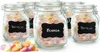 Several glass jars filled with colorful candies are arranged on a white surface, with a pile of loose candies in the foreground. Produktbild-Vorschau