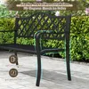 A black metal garden bench is shown outdoors with green foliage and a paved patio. Podgląd zdjęcia produktu