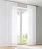 Two white sheer curtains with a wave pattern hang in front of a window, with a view of a green landscape outside. Produktbild-Vorschau