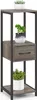 A three-tiered plant stand with a drawer, decorated with potted plants. Produktbild-Vorschau