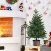 A mini Christmas tree is displayed in a festive setting with a fireplace and Christmas ornaments. Produktbild-Vorschau