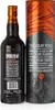 A bottle of Smokehead Rum Rebel whisky and its cylindrical packaging. Produktbild-Vorschau