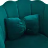 A close-up view of a teal velvet chair with a bow-shaped pillow. Anteprima dell’immagine prodotto