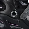 A close-up view of a black inline skate with violet accents. Voir les images du produit