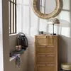 A corner of a room with a wooden cabinet, a mirror, a lamp, and decorative items. Podgląd zdjęcia produktu