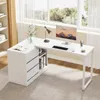 A white L-shaped desk with drawers and shelves, set up in a home office with a large window in the background. Voir les images du produit