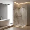 A modern bathroom with a freestanding bathtub and a glass shower enclosure with gold accents. Náhled obrázku produktu