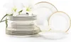 A stack of white porcelain plates and bowls with gold trim, accented by white lilies. Náhled obrázku produktu