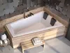 A modern bathroom featuring a built-in bathtub with wooden accents and geometric wall tiles. Produktbild-Vorschau