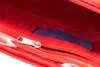 A close-up view inside a red zippered pouch, showing blue and red circular tokens. Anteprima dell’immagine prodotto