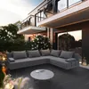 A modern outdoor lounge set on a dark wooden deck, with lush greenery and a contemporary building in the background during sunset. Podgląd zdjęcia produktu