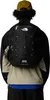 A person wearing a backpack from behind. Produktbild-Vorschau