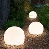 Garden path with illuminated spherical lights. Produktbild-Vorschau