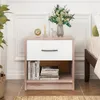 A nightstand with a drawer and an open shelf, placed next to a bed. Podgląd zdjęcia produktu