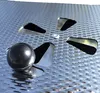 A close-up view of a metal sphere and several metal blades on a textured metal surface. Produktbild-Vorschau