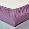 A close-up view of a purple fitted sheet on a bed. Produktbild-Vorschau