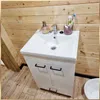 A bathroom vanity with a sink and faucet, set against a wooden wall. Voir les images du produit
