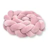 A pink braided pillow on a white background. Produktbild-Vorschau