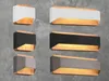 A collage of modern wall lights with different finishes against a concrete wall. Podgląd zdjęcia produktu