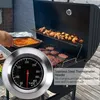 A person grilling food on a barbecue with a thermometer. Produktbild-Vorschau