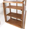 An open wooden greenhouse with clear plastic panels and three wooden shelves. Voir les images du produit