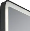 A close-up view of the corner of a black LED mirror with a white light strip. Náhled obrázku produktu