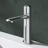 A close-up shot of a modern chrome faucet on a white sink against a textured dark gray background. Produktbild-Vorschau