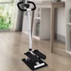 A fitness stepper is shown in a room with wooden floors and a blurred background of furniture and a window. Podgląd zdjęcia produktu