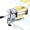 A chrome pasta maker on a glass table with pasta dough being fed through it. Náhľad obrázku produktu